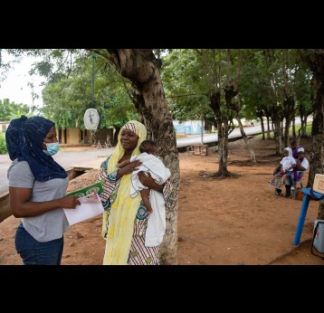 A health worker interacts with a mother during a community health check-up and vaccination. Gavi/2022/Nipah Dennis