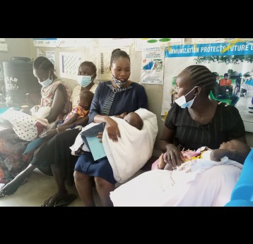 Mothers queue at Munuki Health Center to vaccinate their children