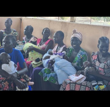 Mothers waiting in a queue at a vaccination center in Minkaman. Credit: Mothers waiting in a queue at a vaccination center in Minkaman