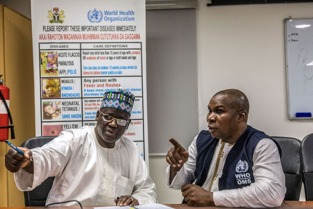 Dr Sule Mele, the Executive Director of the State Primary Health Care Development Agency of Borno State discusses with Dr Audu Idowu, the WHO State Coordinator for Borno in the Borno State EOC. © Andrew Esiebo/WHO