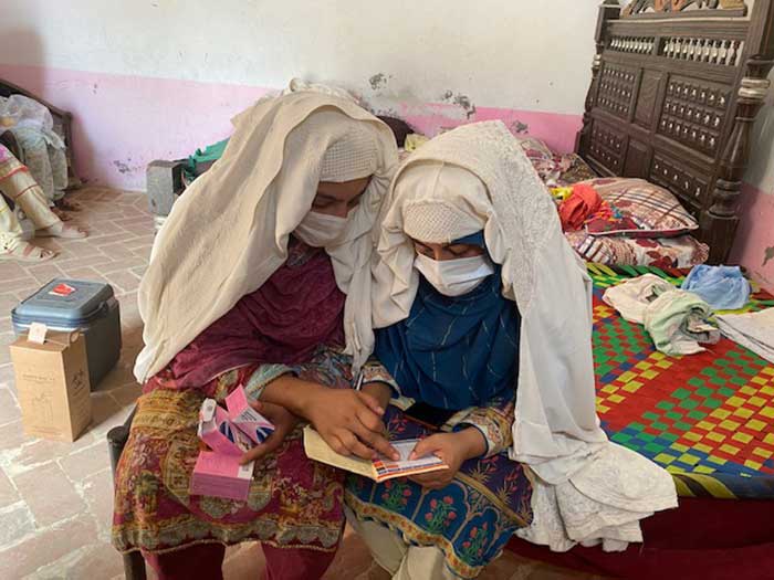 Seemab Begum Social mobiliser and Anisa Sadiq Female Vaccinator of PHC Global filling in the details after vaccination session in village Dumail, District Bannu, South Khyber Pakhtunkhwa, Pakistan