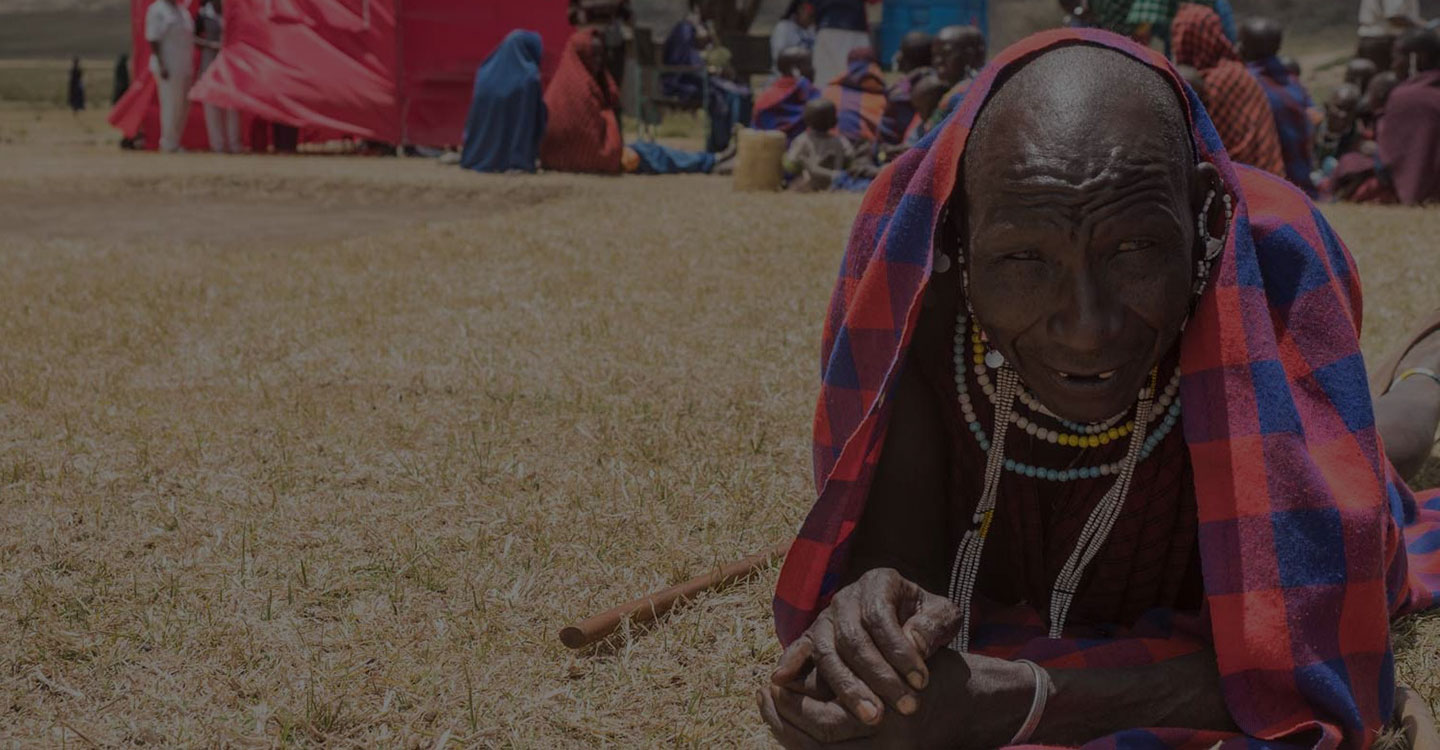 smiling maasai laying in the grass