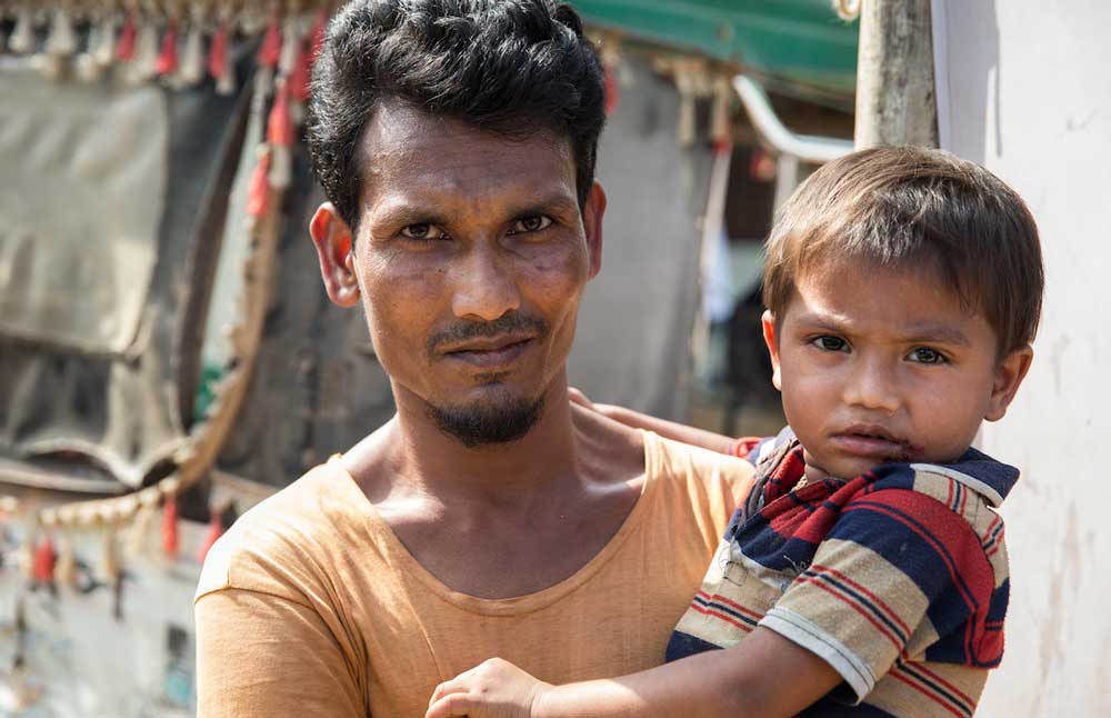 A father and his son at the launch of a cholera vaccination campaign in Bangladesh. Credit: Gavi/2019/Isaac Griberg.