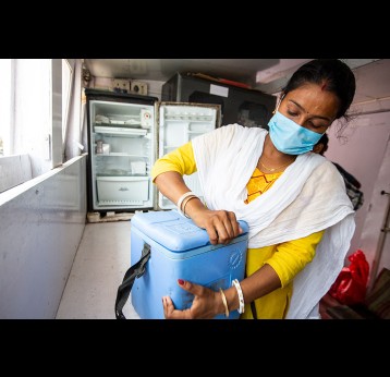 A Nurse on Board the SHIS Hospital Boat is checking the Covishield Vaccine before delivering them to the next Vaccination Point, in the Sunderbarn, India. Gavi/2022/Benedikt v.Loebell