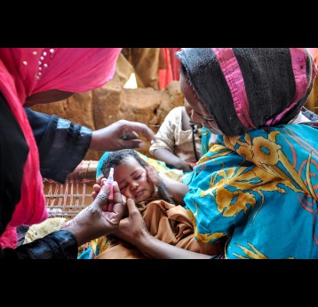 Health worker administering vaccine to baby. Credit: Gavi/Doune Porter