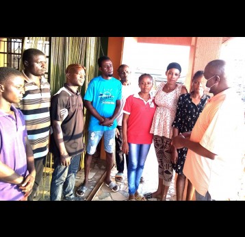 Managing Director, Jeteg Investment Nigeria Ltd, Mr Etim Effiong, counselling people at a pub in Lagos, Nigeria, on the benefits of taking COVID-19 vaccines. Photo credit: Simon Utebor
