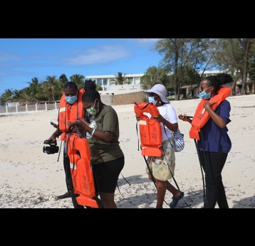 Vaccinated and masked tourists walking towards Malindi marine park in Kilifi County