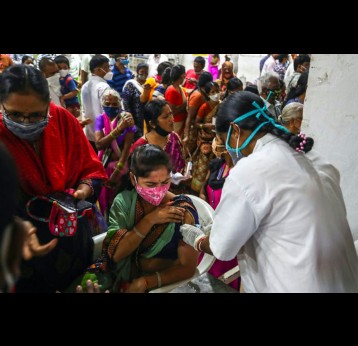 Lining up for a vaccine at a municipal stadium in Hyderabad, India. AP Photo/Mahesh Kumar A