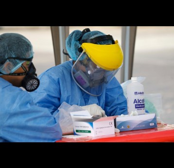 Lima, Peru; may 14,2020: Healthcare workers check blood sample for a rapid diagnostic tests of new coronavirus disease. Credit: Angelica Zari