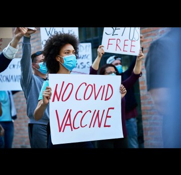 Crowd of people protesting against coronavirus vaccination.