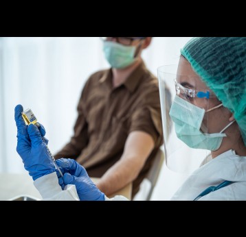 A staff nurse prepares to administer COVID-19 vaccine