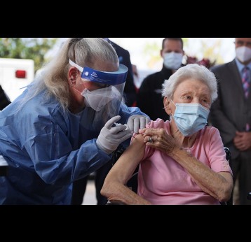 Elderly woman getting a vaccine, photo credit, Joe Raedle