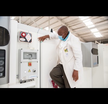 A cold chain engineer installing a Nexleaf sensor in a Kenyan central vaccine store. Credit: Black Swan Mediapg