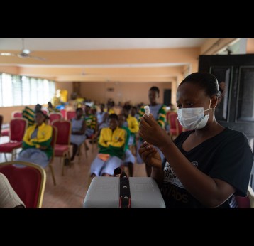 A health worker prepares to vaccinate a student in Adukrom in the Eastern Region, Ghana in 2022. Ghana pushes towards community vaccination to increase its vaccinated population. Gavi/2022/Nipah Dennis