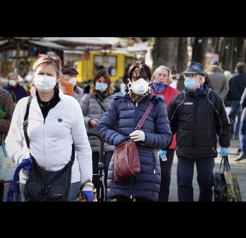 People at marketplace, with face masks for protection from COVID-19.