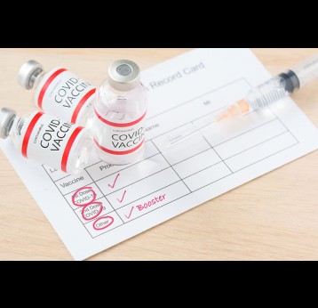 Vaccination record card showing doses of COVID-19 vaccine.