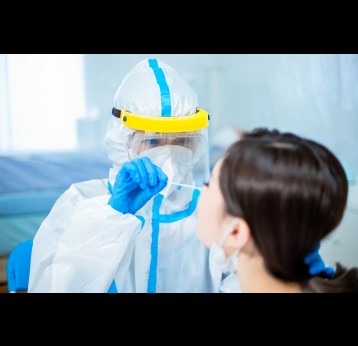Medical worker in protective suit taking a nasal swab