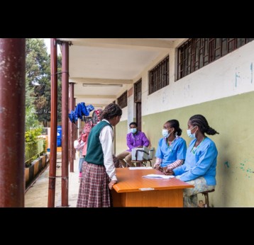 Tsegayenesh Tefera (right) and Zera Jaleta register students for the HPV vaccination at Felege Meles Primary School in Addis Ababa, Ethiopia. Photo: ©Gates Archive/Genaye Eshetu.