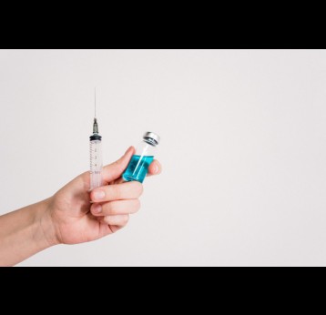 Person holding syringe and vaccine bottle. Credit: Photo by cottonbro studio