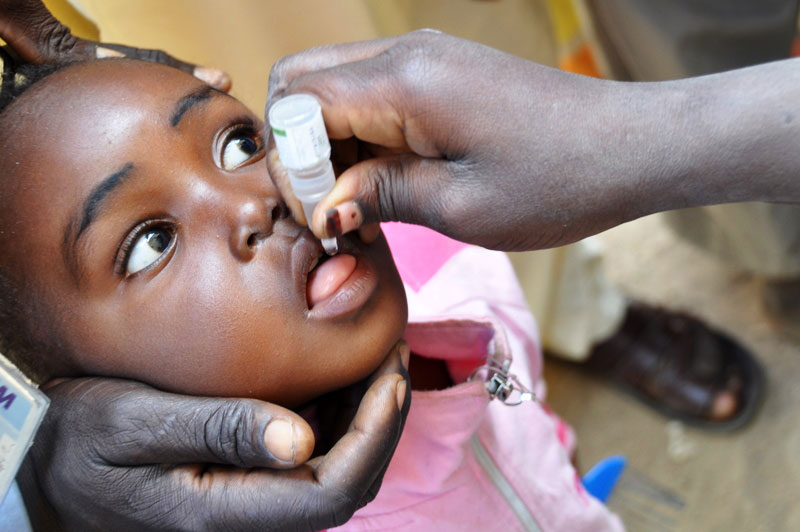 A young girl from Kano state, Nigeria, receiving the life-saving polio drops. © WHO