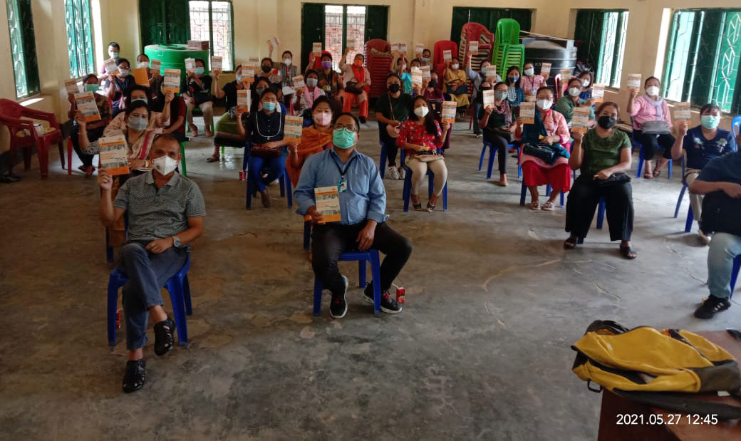 Classroom model training for PCV in the state of Manipur with participants holding the FAQ booklets