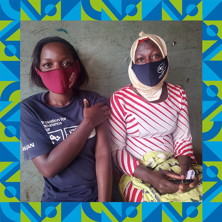 Josephine Nakaayi (left), a teacher at City Primary School, and Rehema Faridah (right), a teacher at Rosa Kindergarten and Primary shortly after they both received their first vaccine doses. Photo by Evelyn Lirri – Design by Miko