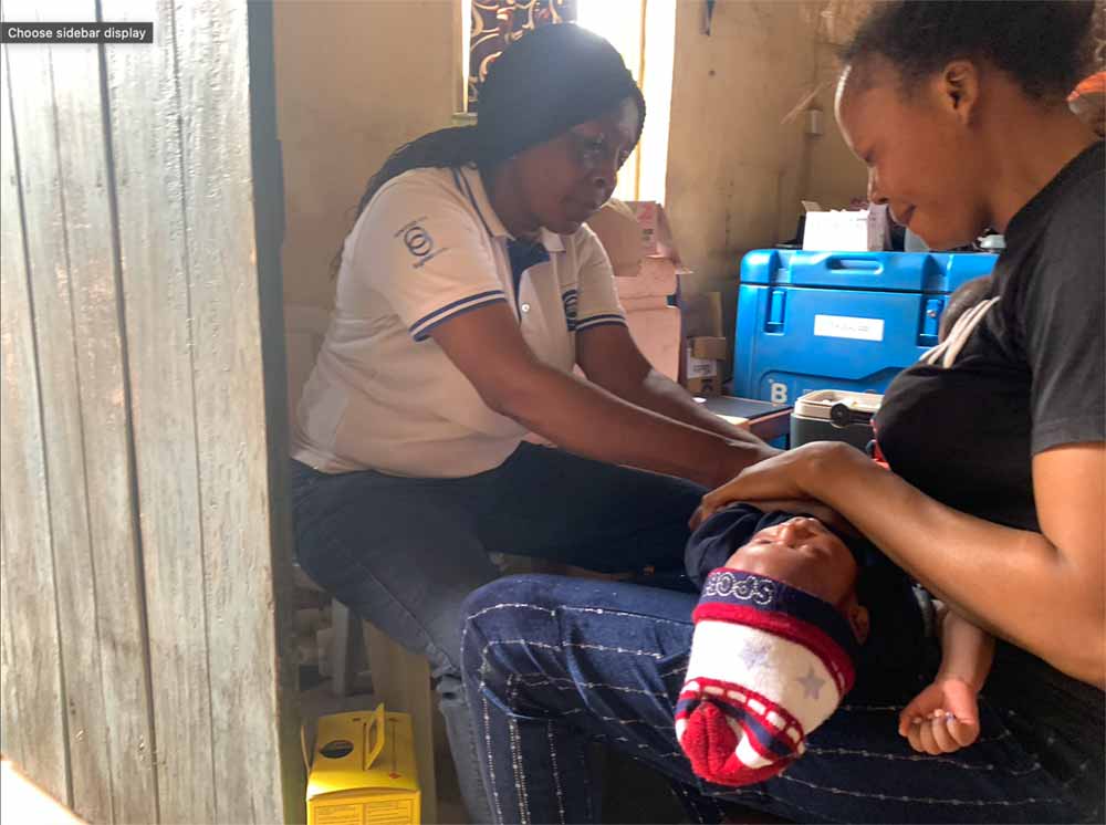 A health worker attends to Agnes' baby at the Mowe Health Centre