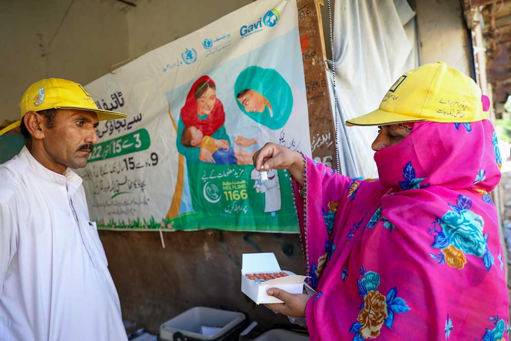 Sharifa bibi, a lady health worker (LHW) checking the Vaccine vial monitor (VVM) before going into the field work during the TCV campaign in Jaffarabad District, Baluchistan Province, Pakistan. Credit: Gavi/2022/Asad Zaidi