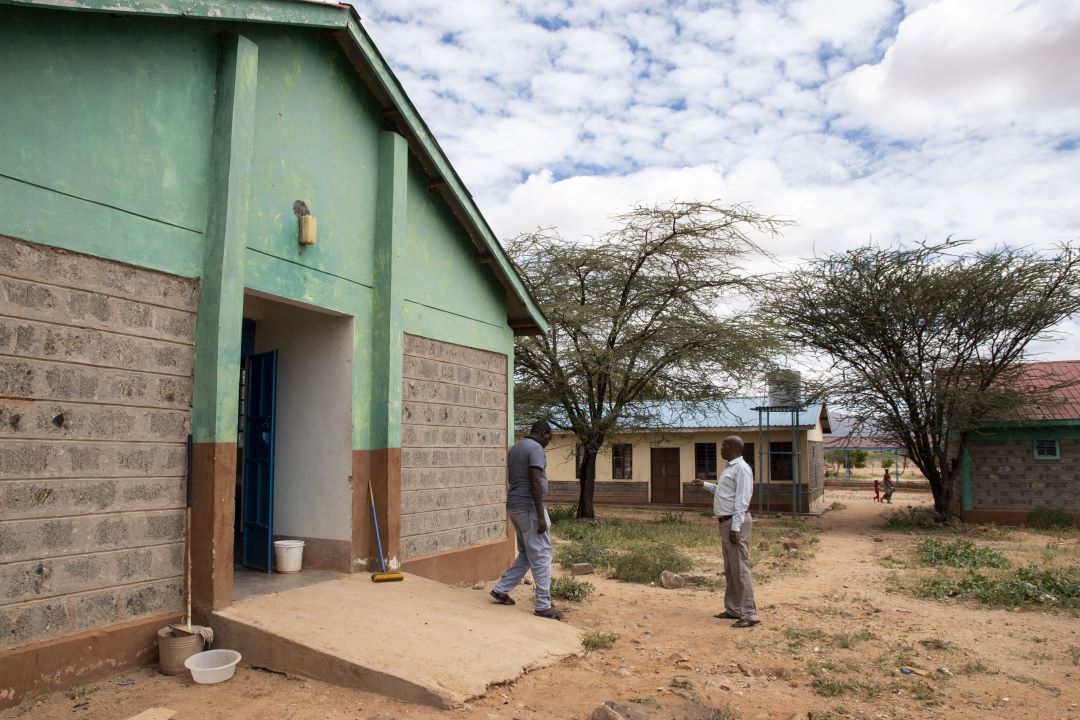 Two doctors emerge from a hospital ward in Laisamis, northern Kenya, which has recorded 30 cases of severe malaria since April. Credit: Claudia Lacave / Hans Lucas