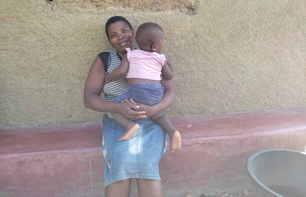 Ms Linet Auma holds her last born one year and six months old son Jayden Otieno during an interview with VaccinesWork