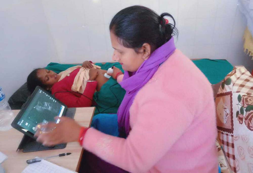 Auxiliary Nurse Midwife (ANM) Chetana Kumari Ojha at the Bhageshwar Basic Health Centre, Dadeldhura, conducts ultrasound examinations for pregnant women. Credit: Chhatra Karki
