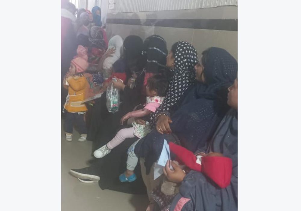 Women in the queue on vaccination day to get their children vaccinated against different diseases at THQ Hospital Gujjar Khan. Credit: Rahul Basharat