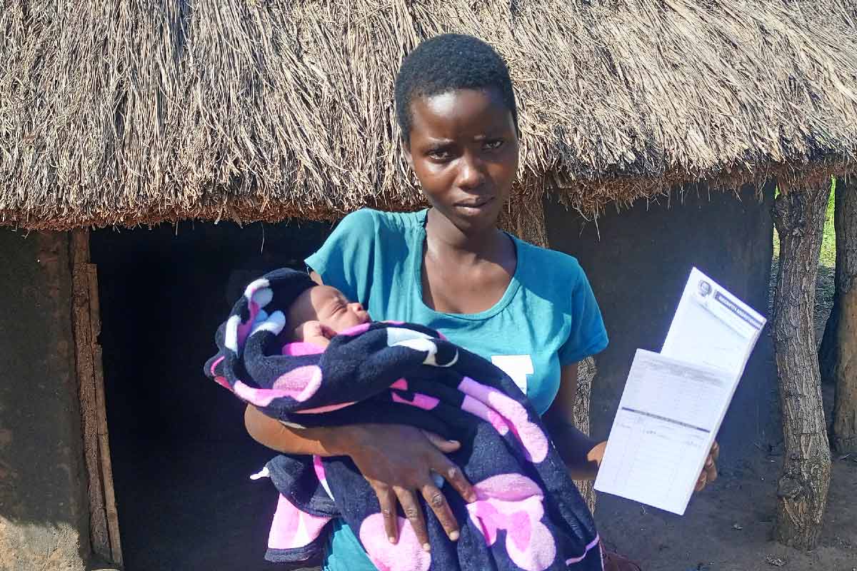 18 year old Kevin Ajolorwot holding her one week baby who was vaccinated against hepatitis B. Credit: John Musenze