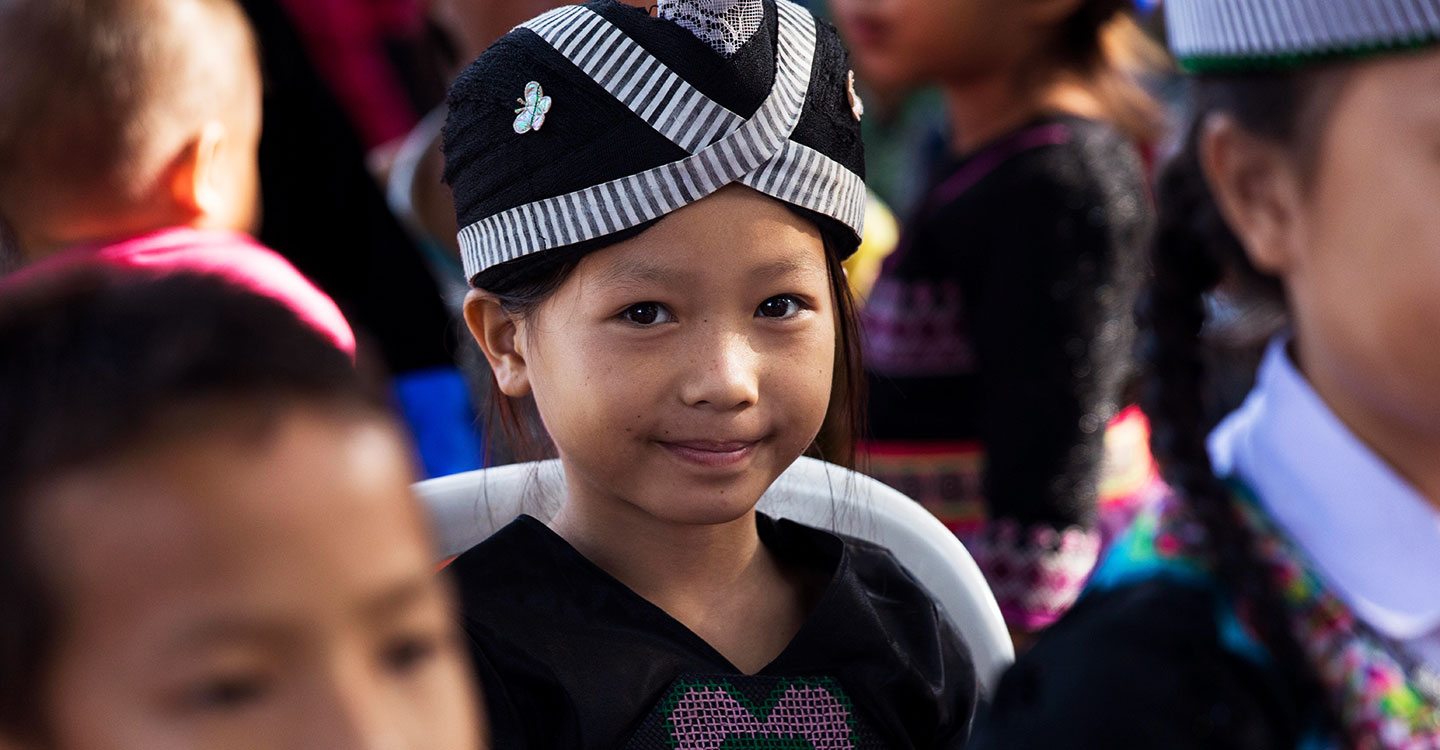 A girl in a crowd in Laos during a Gavi Board visit
