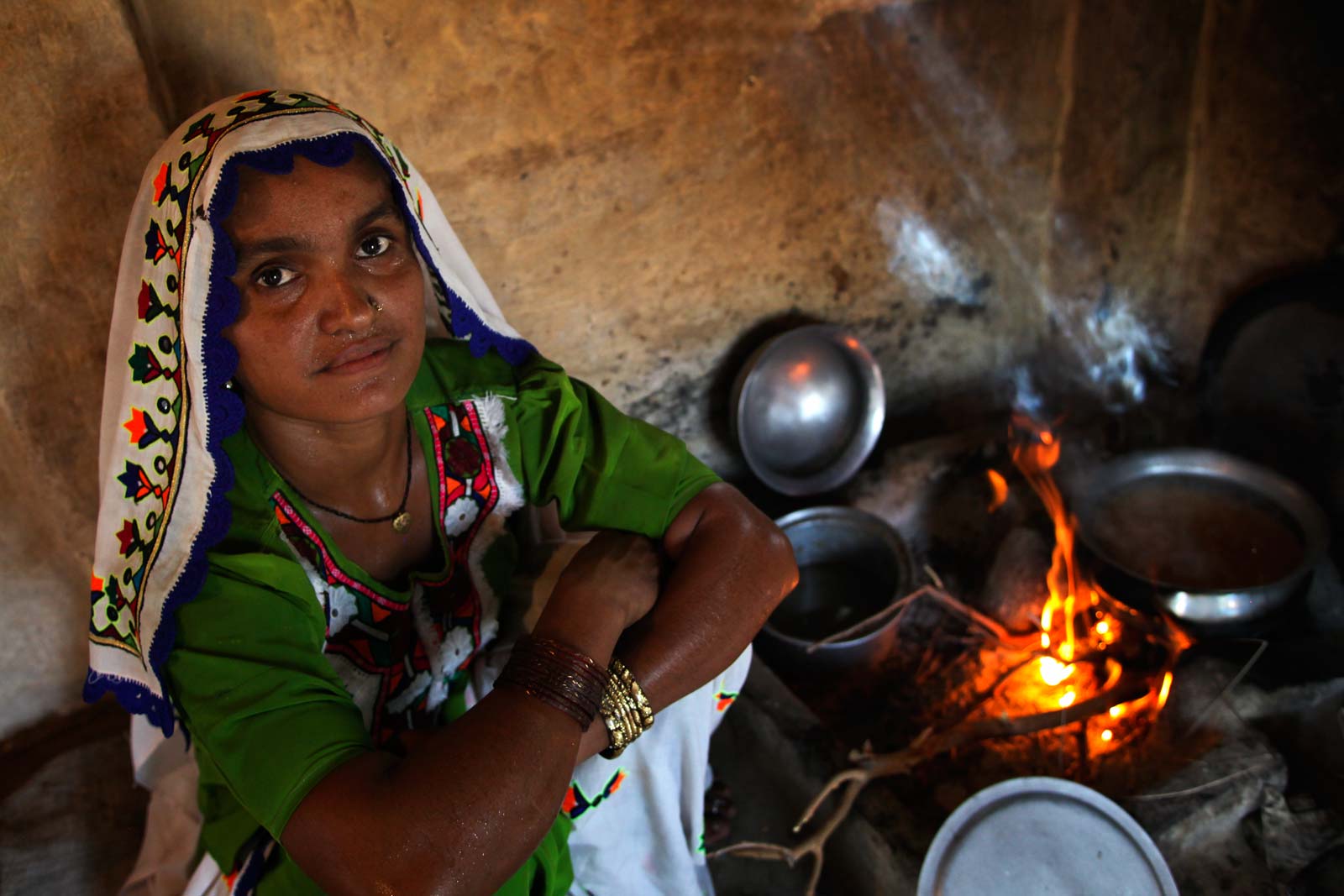 As dawn breaks Lady Health Worker Shankotila Bai prepares a breakfast of chapattis for her husband and three children. In a couple of hours, she will assume her duties attending to the basic health needs of the women and children among the 2,000 people in her village, Mithrio Bhatti, in the Thararkar district of Sindh Province.