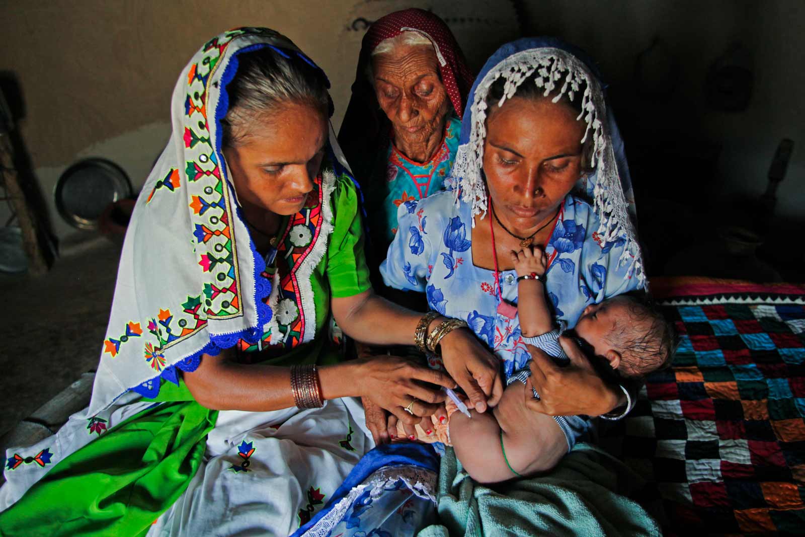   Bai vaccine contre le pneumocoque le bébé Jetesh, tandis que sa mère, Seeta Bai, âgée de 27 ans, câline ce dernier. Bai vient également de lui administrer les vaccins pentavalents et antipolio.