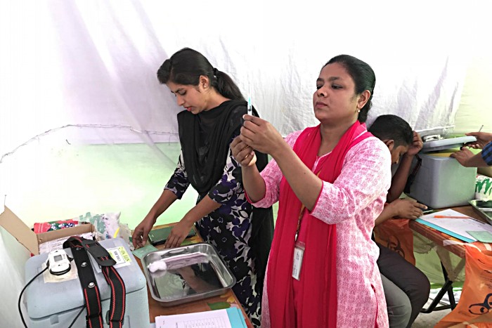 Healthcare workers get ready to deliver the typhoid conjugate vaccine (TCV) during a 2018 clinical trial in Bangladesh. A significant portion of typhoid cases occur in children under 5, and the new conjugate vaccine can be administered to children as young as 6 months old while providing longer-lasting immunity than previous vaccines. Expanding coverage will not only save lives and decrease the burden of the disease: the WHO recommends the typhoid vaccine as an important step to help low- and middle-income 