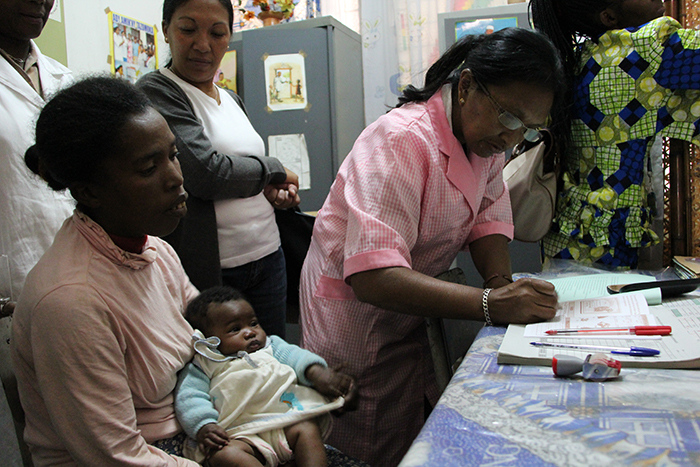 Doctor Hanintsoa Rakotoarimanga checks a mother’s immunisation record before giving the pentavalent vaccine at a health point in Isotry, a district of Madagascar’s capital, Antananarivo.