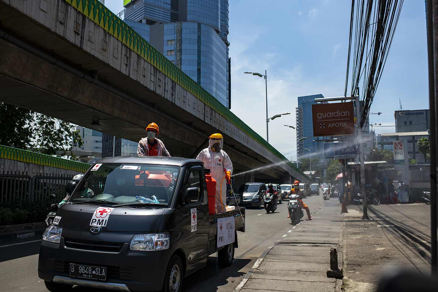 The Indonesian Red Cross spraying disinfectants on its own streets to fight with Covid-19 in Jakarta, Indonesia in March, 2020.  Credit: UNICEF/2020/Arimacs Wilander
