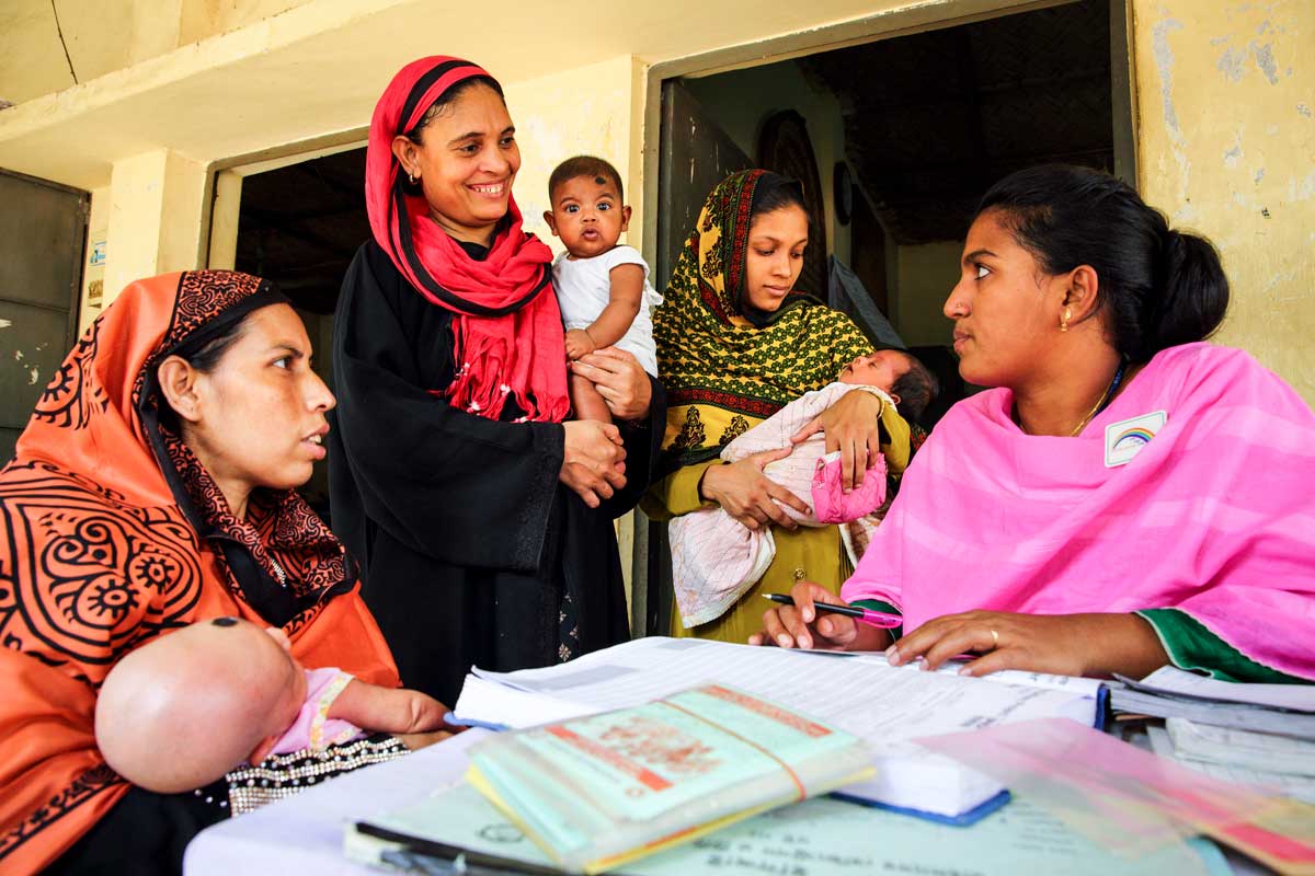 Parents with their children at a vaccination session