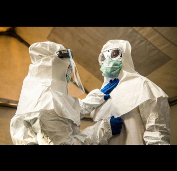 Medical staff check each others protective suits. Photo by SUMY SADURNI/AFP via Getty Images