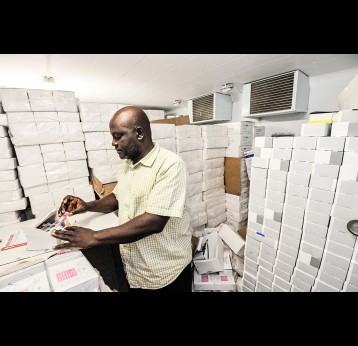 A cold room administrator checks vaccine stocks in Nigeria. Credit: GAVI/2013/Adrian Brooks