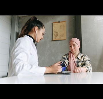 Female doctor checking cancer patient's blood pressure. Photo by Thirdman from Pexels
