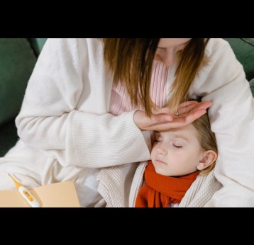 Woman checking her child's temperature. Credit: Tima Miroshnichenko/Pexels