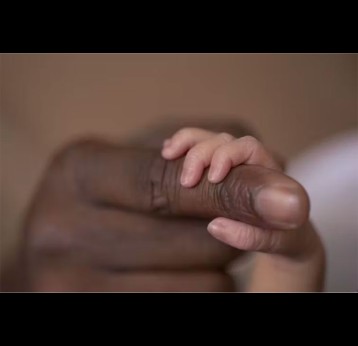 A newborn baby holds a father’s finger. Credit: Getty Images