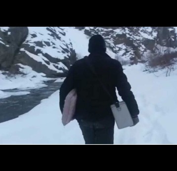 Health worker SulemanSuleman, with vaccines and other medical aid, on the path to Itchoo amidst snow and ice. Credit: Block Medical Office, Sankoo.