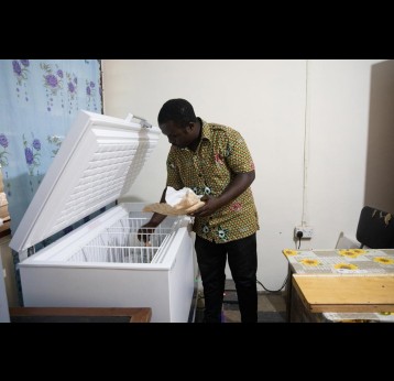 Abednego Piedu, a Principal Community Health Nurse, stores a medical delivery into a fridge at the Adukrom Health Centre in Eastern Region, Ghana. Credit: Gavi/2022/Nipah Dennis
