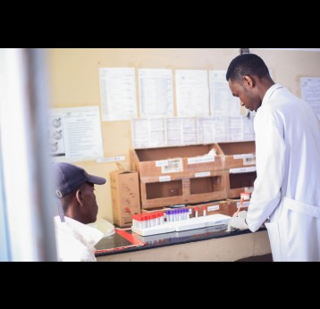 A lab technician works on a sample drawn from patient seeking treatment for reproductive health services at Maswa District Hospital. Credit:  Syriacus Buguzi
