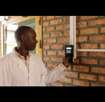 Dr. Alfred, the lead physician at Nyamata District Hospital, shows off the fingerprint-recognition technology. Credit: Erin Hohlfelder.