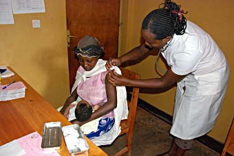 Rwanda health clinic, nurse giving injection
